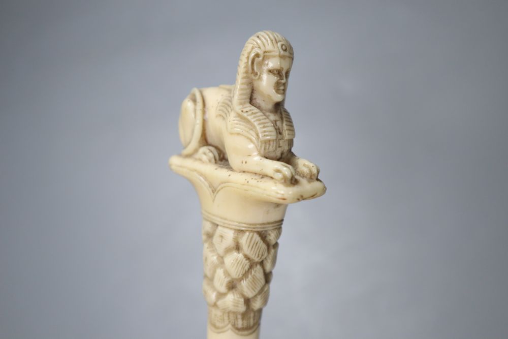 An ivory sphinx parasol handle, 84cm